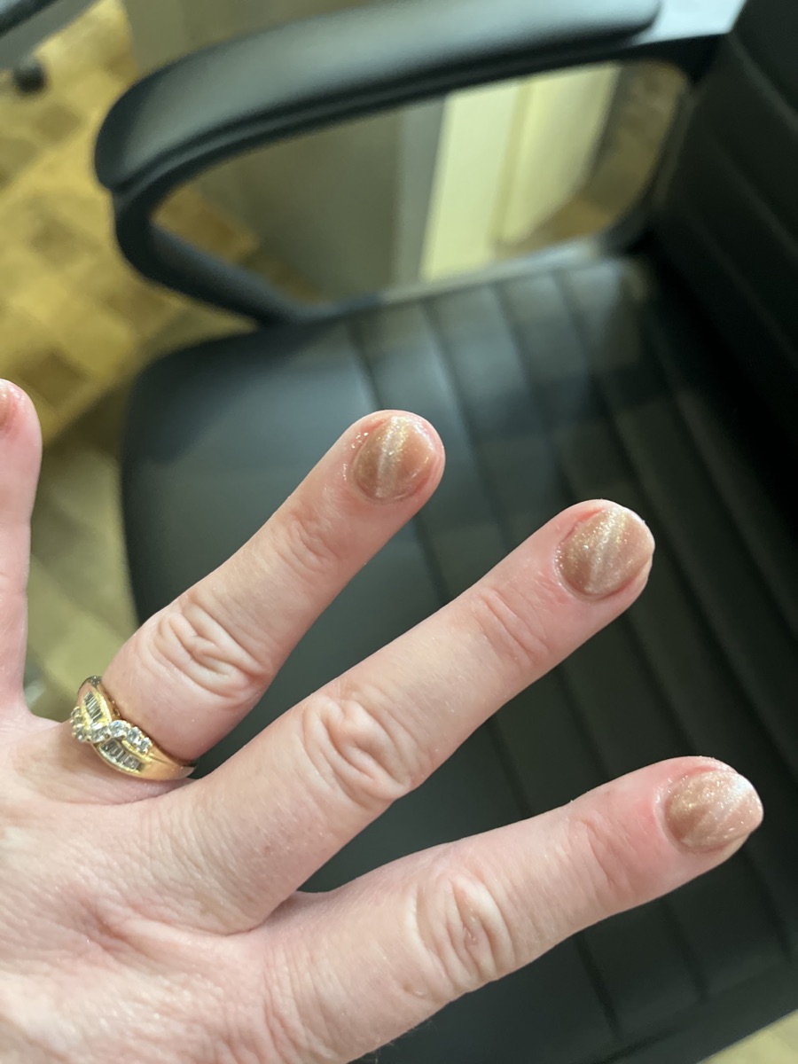 Soft nude nails with a fine glitter shimmer.